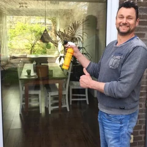 Tevreden klant naast het glas in de schuifpui